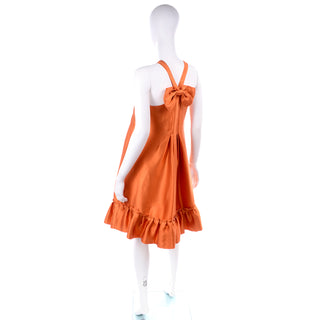 Moschino Sleeveless tent dress with ruffled hem and bow in back