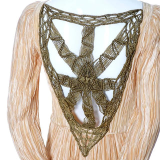 Gold macrame on the back of a 1980's pleated silk Mary McFadden Evening Gown vintage dress