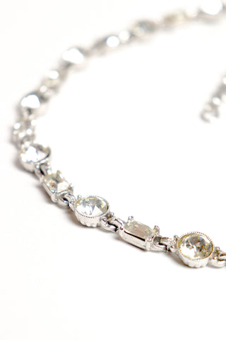 Detail of crystal necklace with alternating round and rectangular crystals