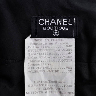 Chanel Boutique 1990's black boucle wool suit with black plastic trim