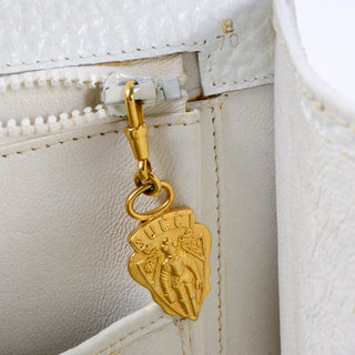 Gucci gold medallion zipper pull 