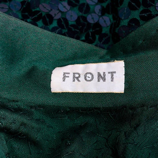 Front label for a Norman Norell vintage green dress